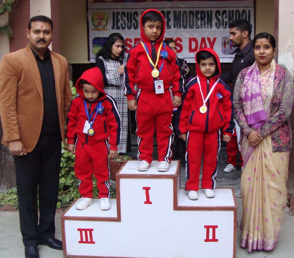 Students receiving medals on the sports day podium